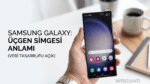 Bir elinde Samsung Galaxy akıllı telefon tutan kişi; ekranın sağ üst köşesinde veri tasarrufunun açık olduğunu gösteren, içinde yukarı ve aşağı oklar bulunan üçgen simgesi daire içine alınarak vurgulanmış. Görselin solunda "SAMSUNG GALAXY: ÜÇGEN SİMGESİ ANLAMI (VERİ TASARRUFU AÇIK)" yazısı bulunuyor.